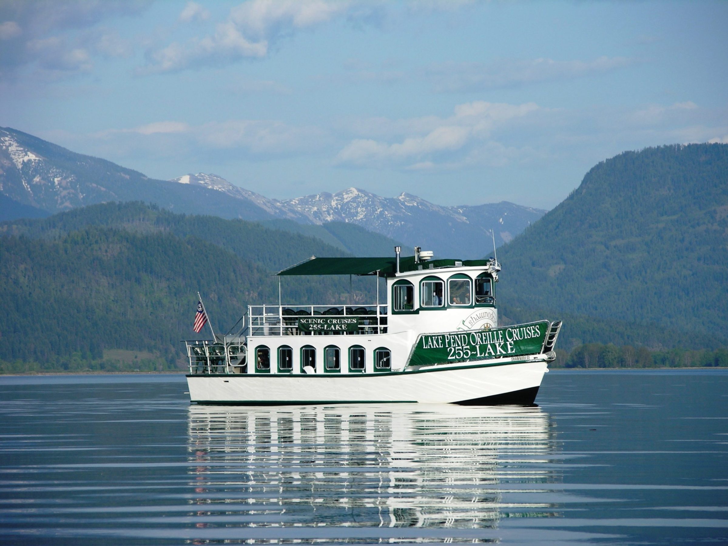 a small boat in a body of water with a mountain in the background