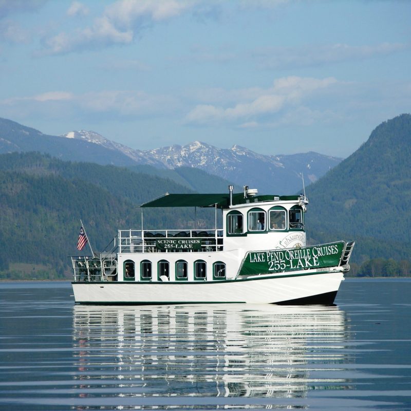 a small boat in a body of water with a mountain in the background