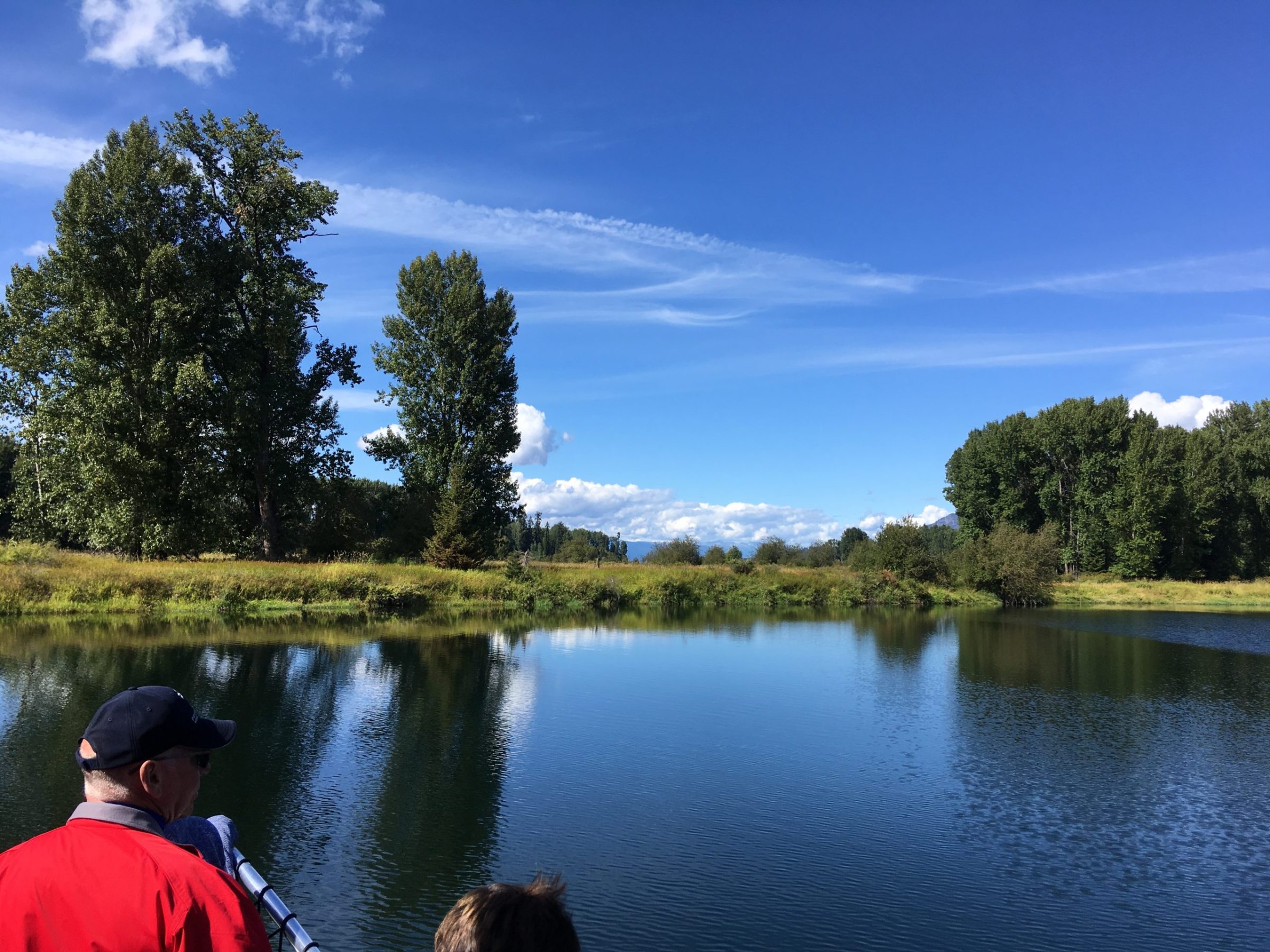 a man standing next to a body of water