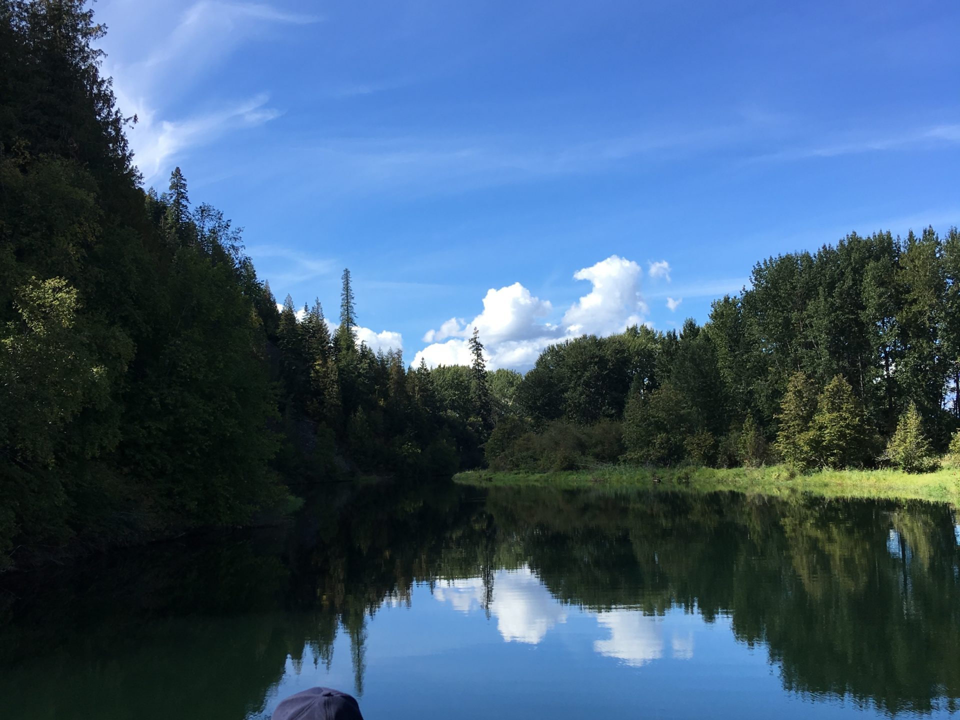 a man standing next to a body of water