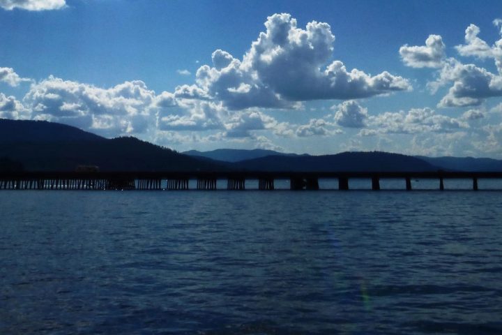 a group of clouds in the sky over a body of water