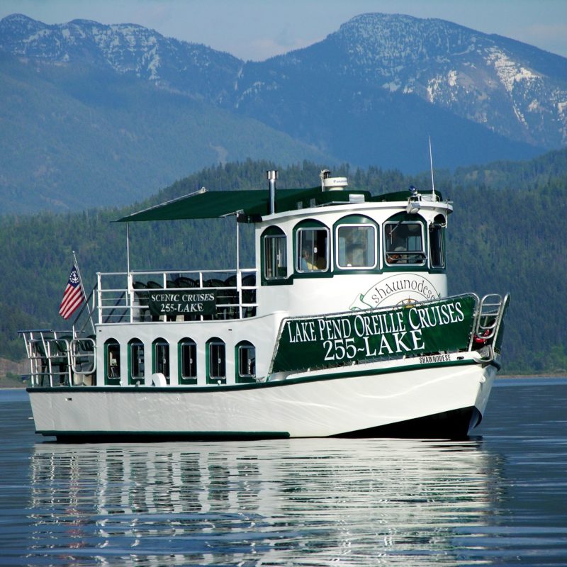 a small boat in a body of water with a mountain in the background